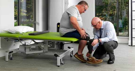 Prosthetist With Patient Sitting