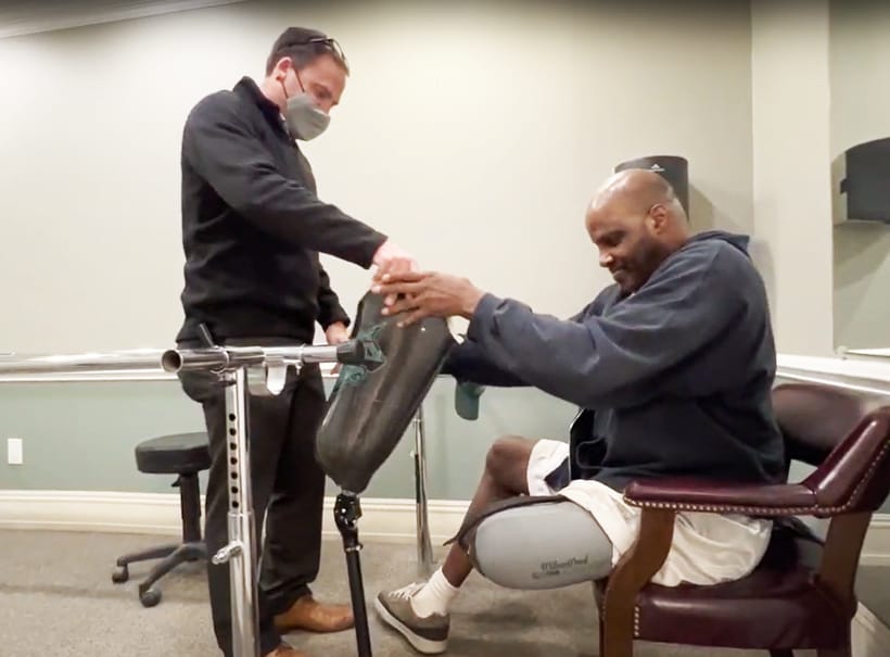 Mike Assisting Patient In Clinic