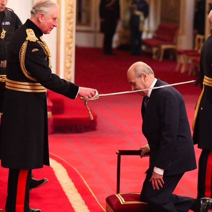 Saeed being Knighted by King Charles